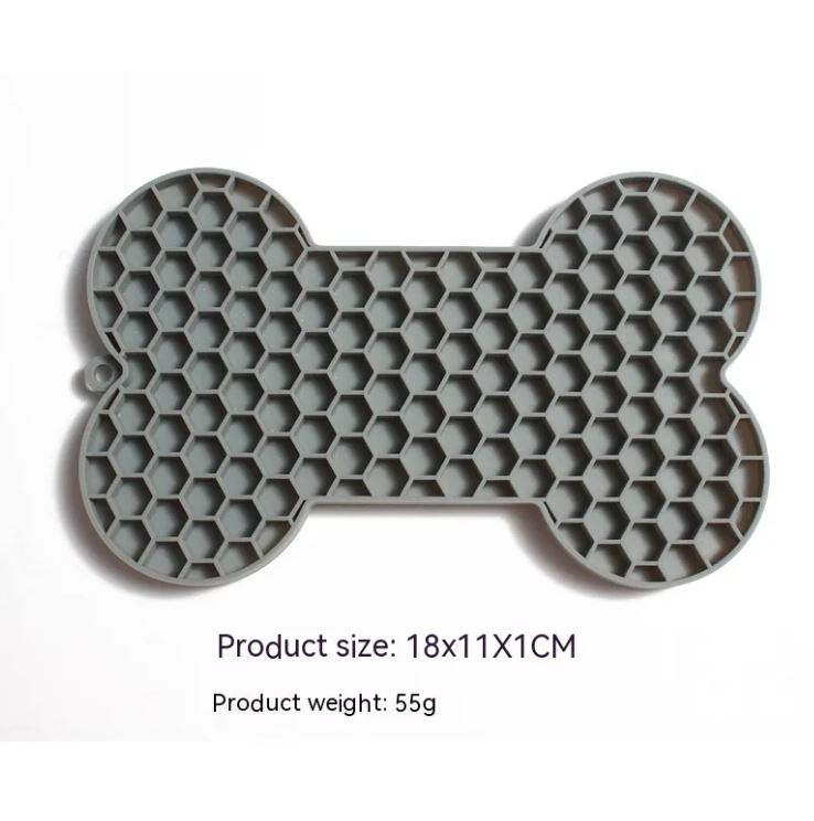 Gray bone-shaped silicone dog slow feeder lick mat with raised honeycomb texture, size 18 x 11 x 1 cm and weight 55 g shown on image