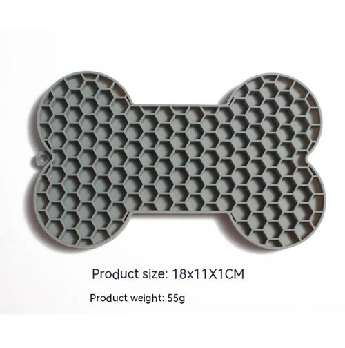 Gray bone-shaped silicone dog slow feeder lick mat with raised honeycomb texture, size 18 x 11 x 1 cm and weight 55 g shown on image
